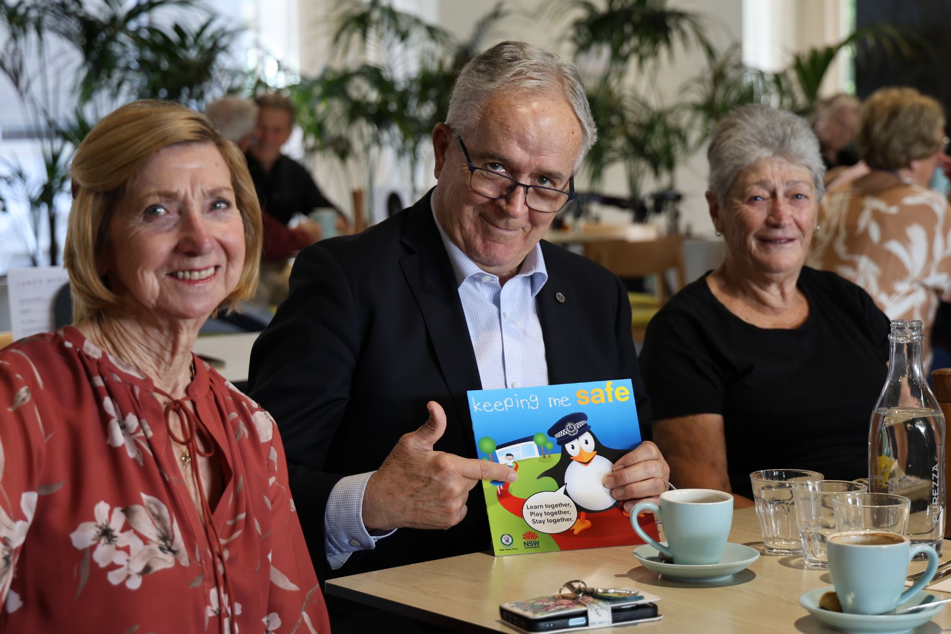Panthers Chairman, Peter Graham with children's safety book and local residents